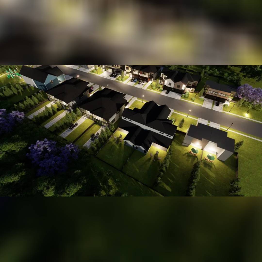 Aerial view of a modern residential neighborhood at dusk with streetlights on.