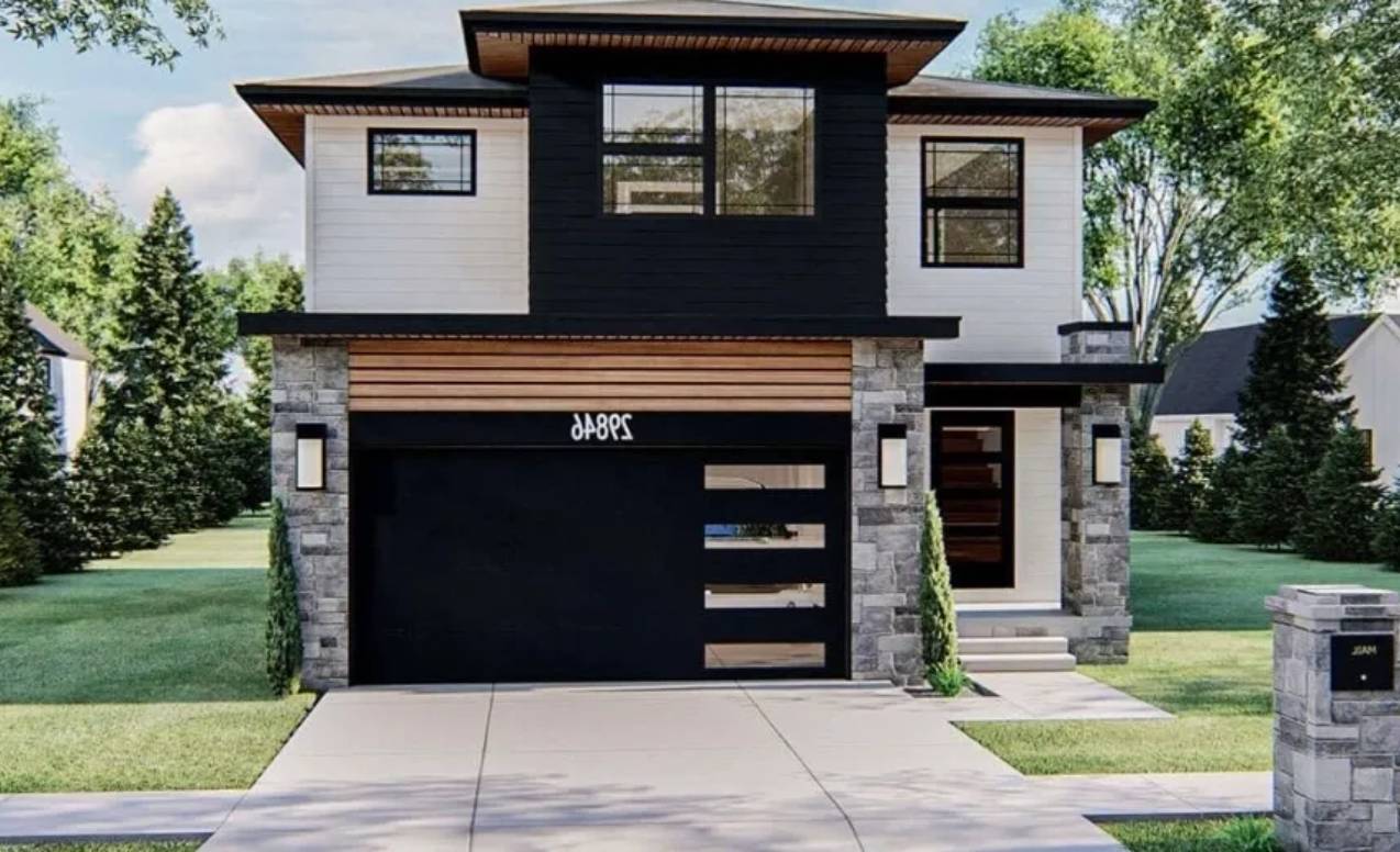 Modern two-story house with black garage door and stone accents.