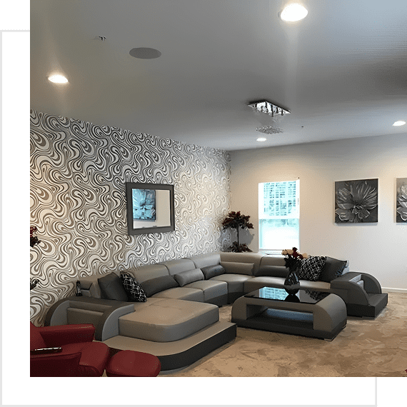 Modern living room with sectional sofa and patterned wallpaper.