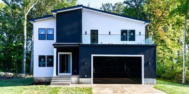 Modern two-story house with black and white exterior.